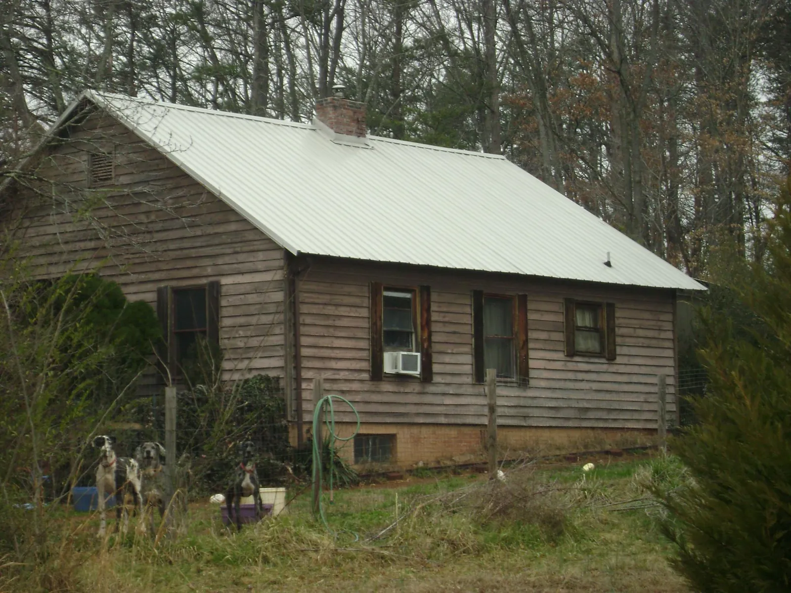 White metal roof on an old wood sided farmhouse, from a Metal Roof Installation job in Prospect